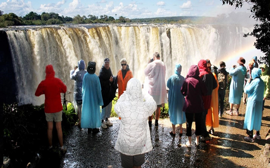 Foreign tourists visit the Victoria Falls after the Harare International Carnival