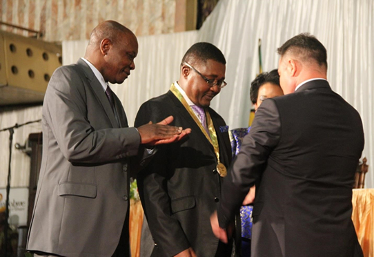 Hon. Minister of Tourism & Hospitality Industry W. Mzembi receiving the Favorite Cultural Destination or 2014 from Professor Anton Caragea
